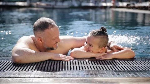 Father with young son playing and having fun on summer vacation in swimming pool Stock Footage 267284706