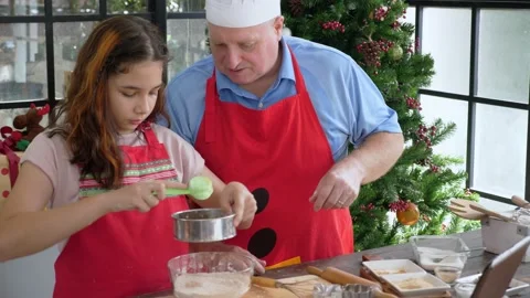 Father&amp;Daughter preparing ginger bread cookie ingredient, seiving nutmeg ground Stock Footage 140077092
