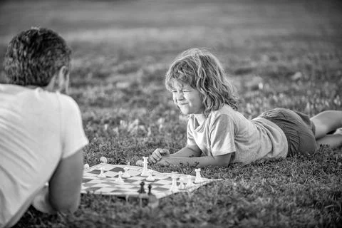 Fatherhood and childhood. checkmate. spending time together. strategic and Stock Photos