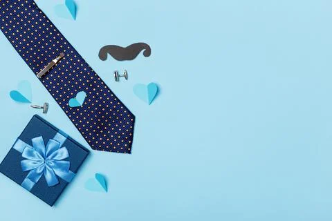 Father's day concept postcard. Men's tie box with a gift paper mustache Stock Photos