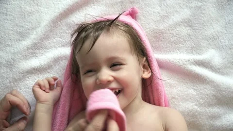 Father's hands wipe wet face and hair of... | Stock Video | Pond5