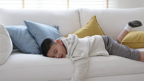 Fatigue in children fall down on sofa at home need rest brain break. Video stock 152577431