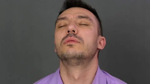 Fatigue on the face of a young man close-up. 動画素材 131297621