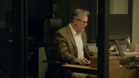 Fatigued Male Analyst Dozing Off in front of Computer at Midnight Stock Footage 331853388