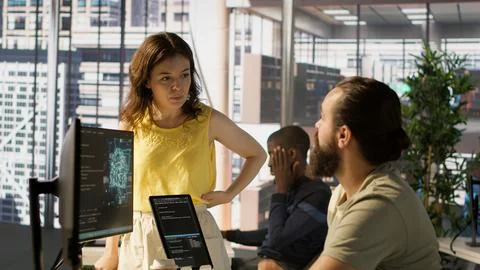 Fatigued software engineer caught asleep at desk by manager Stock Photos