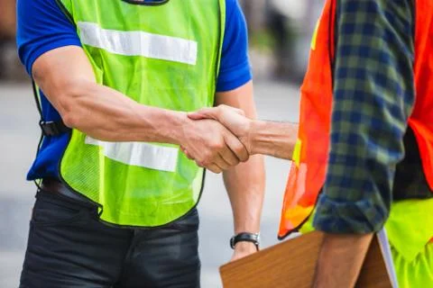 Fatory worker handshake with blurred construction site, Success and Teamwork 写真素材