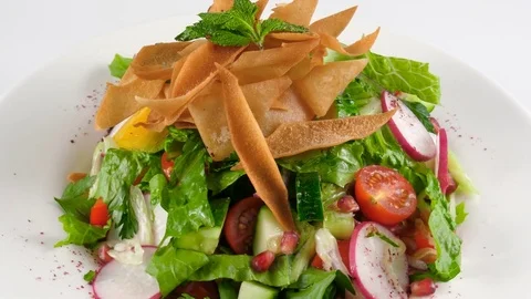 Fattoush, Levantine bread salad made from fried pieces of Arabic flat bread Stock Footage 78185719