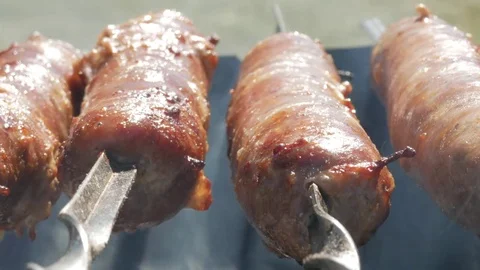 Fatty appetizing sausages cook on fire. Fat drips into the fire. A lot of smoke Stock Footage 78550808