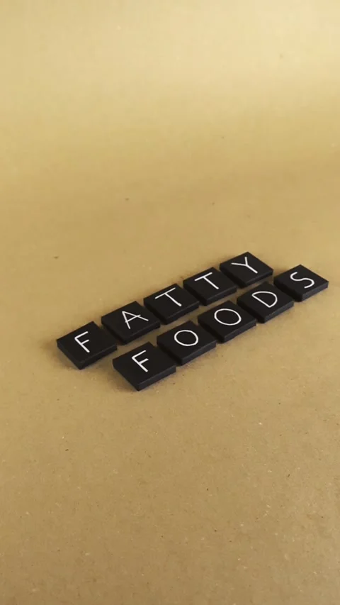 Fatty foods text on a brown background Stock Footage 342528727