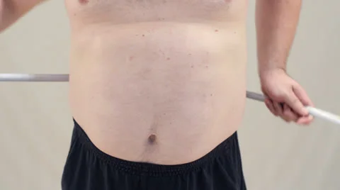Fatty measuring his belly Stock Footage