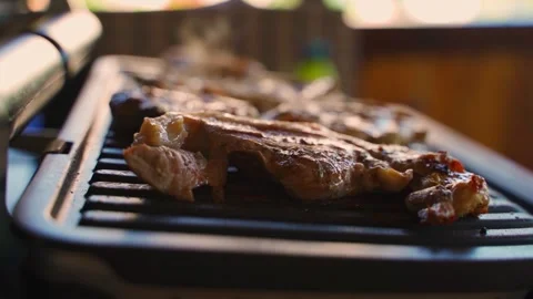 Fatty meat being fried on an electric grill, close-up Stock Footage 317533490
