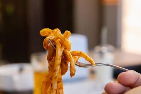 Fatty pasta on fork, close up view. Lagman noodles. concept of obesity Stock Photos