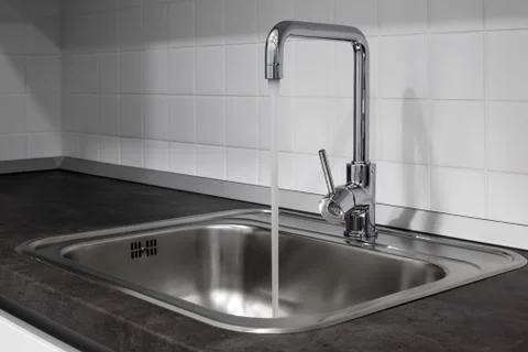 Faucet and sink in the kitchen Stock Photos