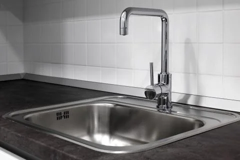 Faucet and sink in the kitchen Stock Photos
