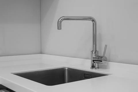 Faucet and sink in the kitchen Stock Photos
