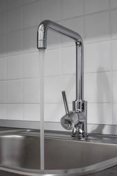 Faucet and sink in the kitchen Stock Photos