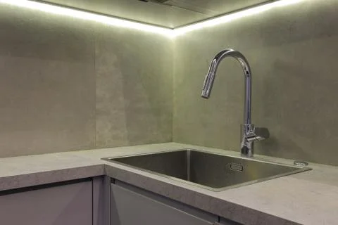 Faucet and sink in the kitchen Stock Photos