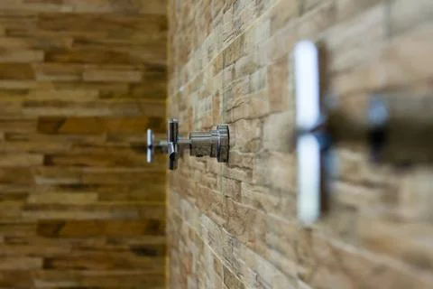 Faucet on brick wall background Stock Photos