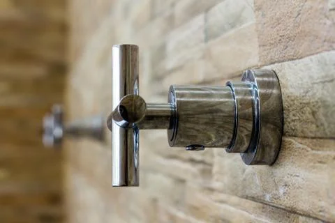 Faucet on brick wall background Stock Photos