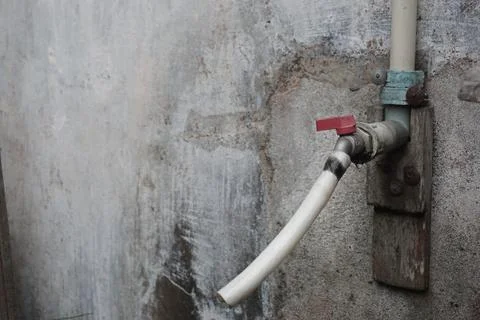Faucet on cement wall Foto stock