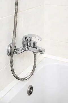 Faucet close-up over bathtub in the bathroom Stock Photos