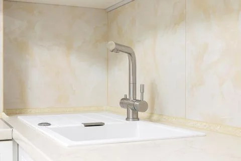 Faucet with granite sink in the kitchen Stock Photos