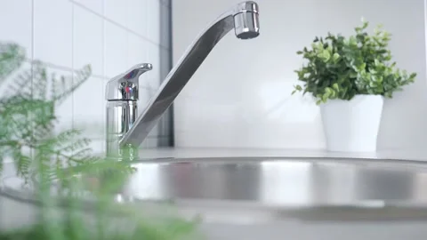 Faucet in kitchen. Water consumption, environment, water pollution and water Stock Footage 210843321