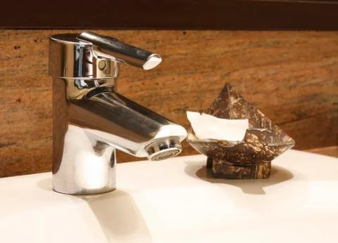Faucet with soap in coconut shell Stock Photos