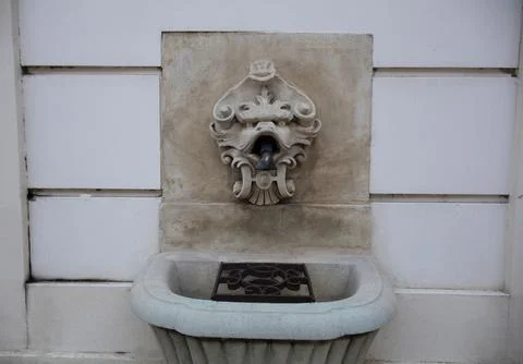 A faucet with water in the shape of a creature Stock Photos