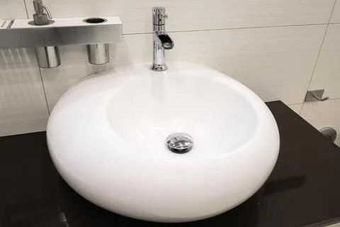 Faucet with white ceramic sink close-up Stock Photos