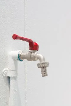 Faucet on white wall Stock Photos