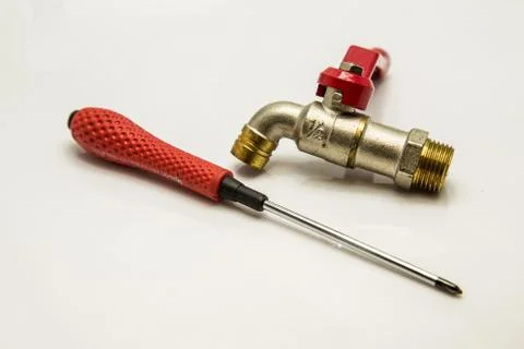 Faucets and screwdriver Stock Photos