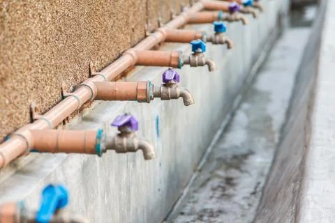 Faucets on wall 스톡 사진