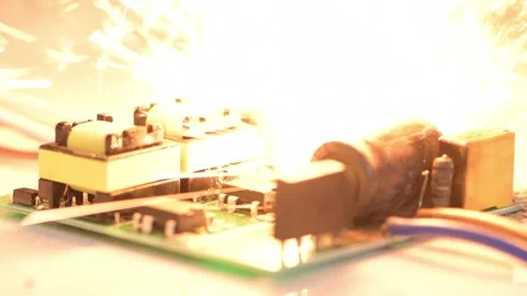 Faulty electronic circuitry with visible damage and sparks. Photo shows a seriou Stock Footage 310038178
