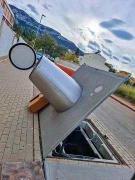 Faulty trash can being repaired in a residential area near mountains during.. Fotos de archivo