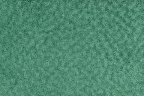 Faux fur texture with wavy effect, fluffy velours green fabric or cloth, up.. Stock Photos