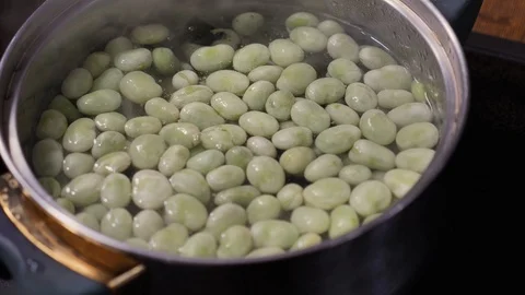 Fava beans being blanched in in boiling, salted water Stock Footage 88110960