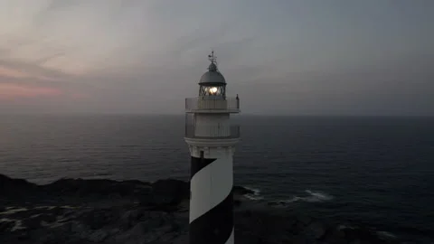 Favaritx lighthouse fast orbit sunset drone aerial rocky clifftop in Menorca Stock Footage 238994735