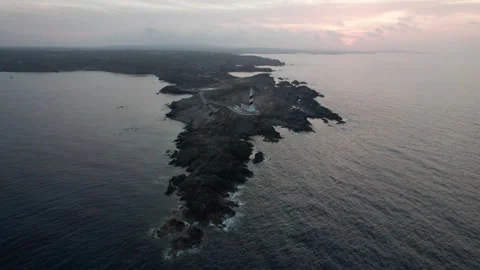 Favaritx lighthouse orbit sunset drone aerial rocky clifftop in Menorca Stock Footage 238994644