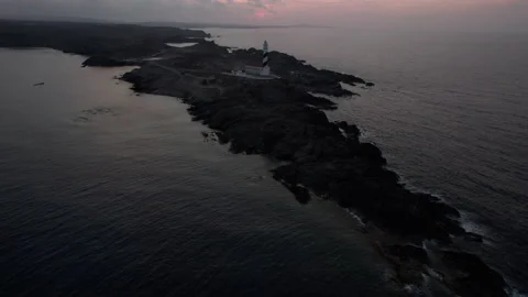 Favaritx lighthouse revealing sunset drone aerial rocky clifftop in Menorca Stock Footage 238995073