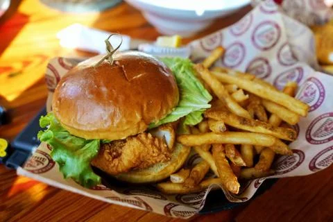 A favorite Cod Fish and Chips sandwich with fries. Stock Photos