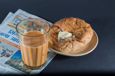Favorite indian breakfst with tea and bun butter against black background Stock Photos