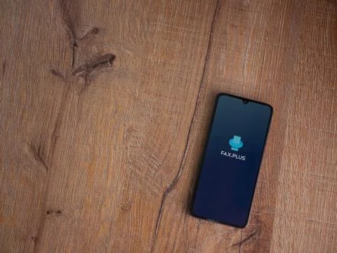 Fax Plus app launch screen with logo on the display of a black mobile smartph Stock Photos