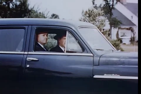 FBI agent keeps a watch on suspect and confirms his identity - 1951 Stock Footage 105741385