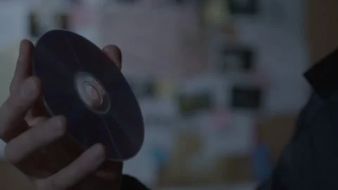 FBI agent looking at CD close up Stock Footage 312455508