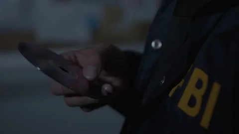 FBI agent looking at CD Evidence Stock Footage 312455512