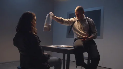 FBI agent shows drug package to suspect Stock Footage 128630123