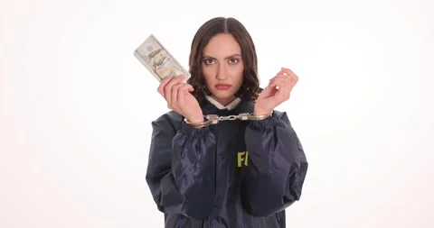 FBI agent shows hands in handcuffs holding stack of dollar bills Stock Footage 317175200