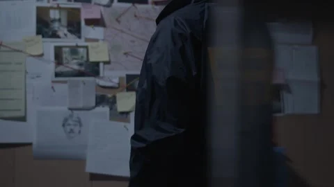 FBI agent standing at Evidence Board Stock Footage 312455227