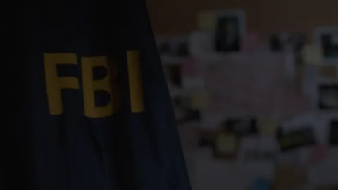 FBI Jacket hung up with Evidence Board Behind Stock Footage 312455727